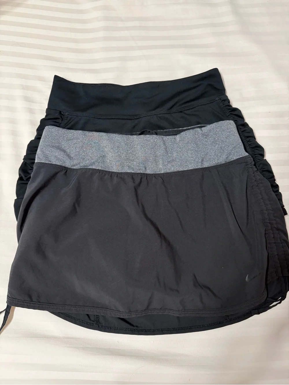 Two Nike Black Tennis Skirts 1 with Gray Waistband